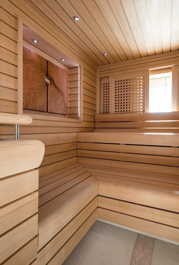 a wooden staircase with a mirror aboard PLVS VLTRA Yacht for Sale