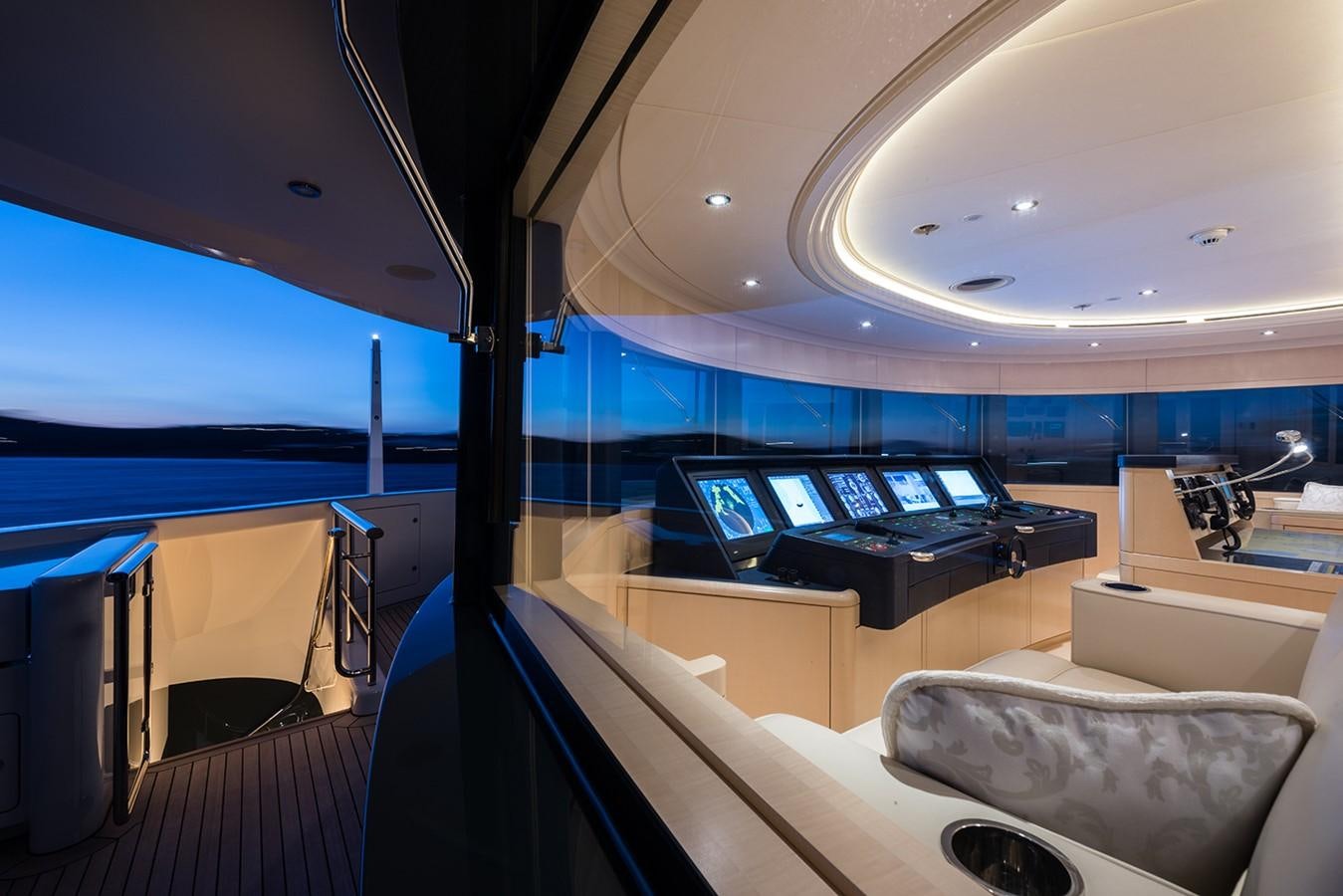 inside of a building with a large window and a desk with a computer on it aboard PLVS VLTRA Yacht for Sale