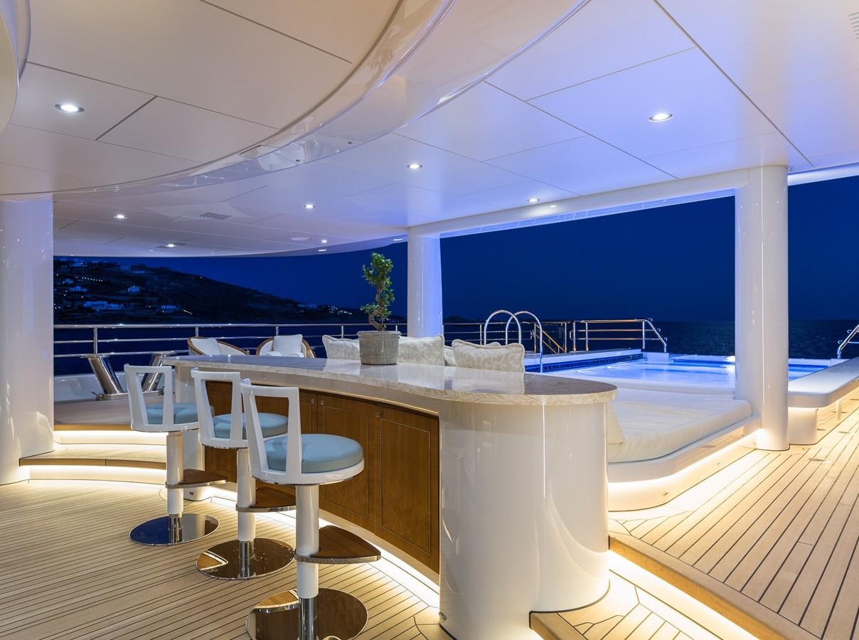 a room with a table and chairs aboard PLVS VLTRA Yacht for Sale