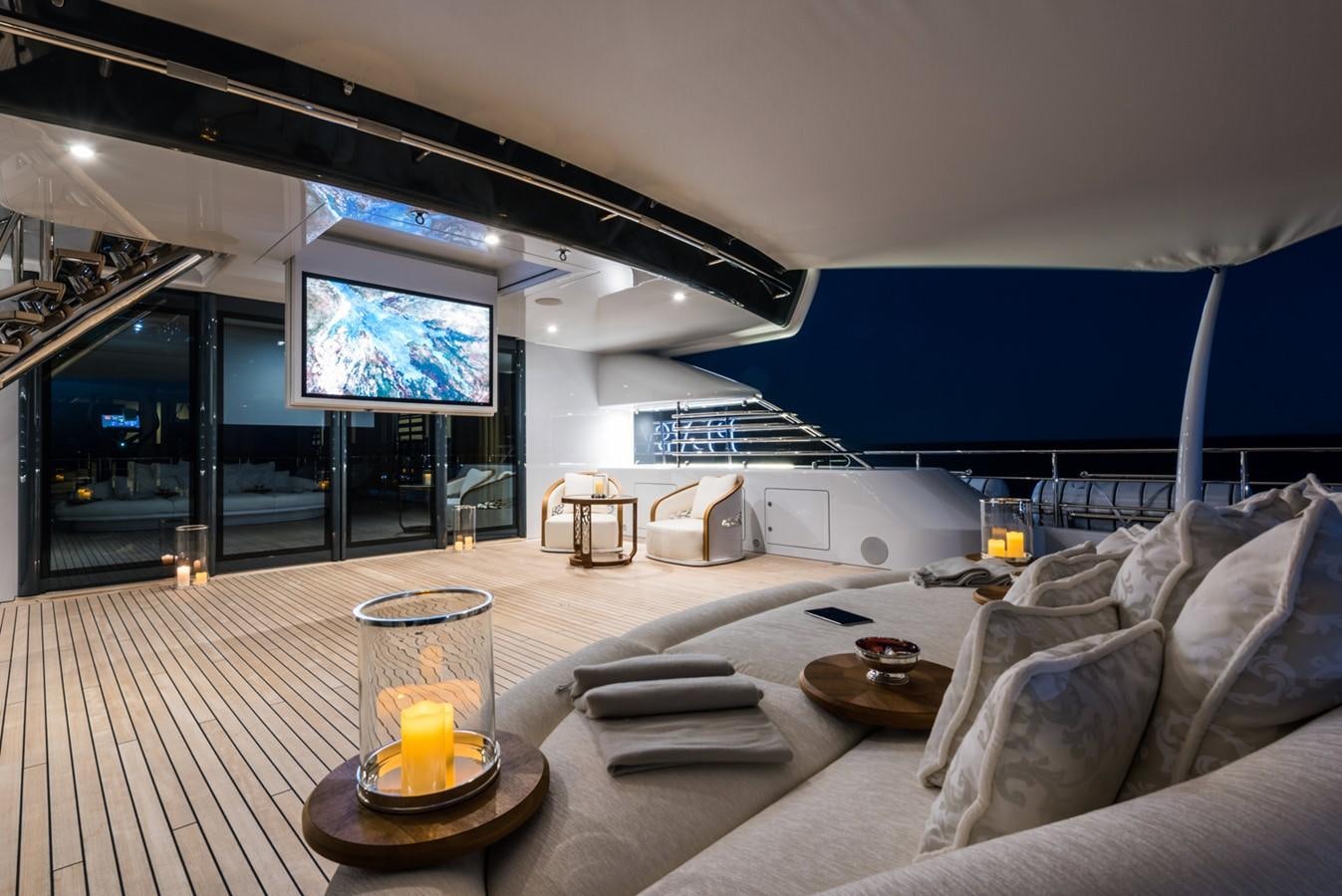 a room with a couch and a table and a television aboard PLVS VLTRA Yacht for Sale