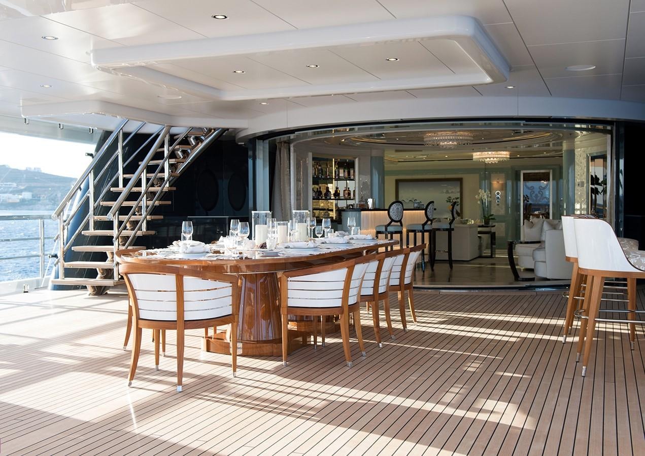 a table and chairs in a room aboard PLVS VLTRA Yacht for Sale