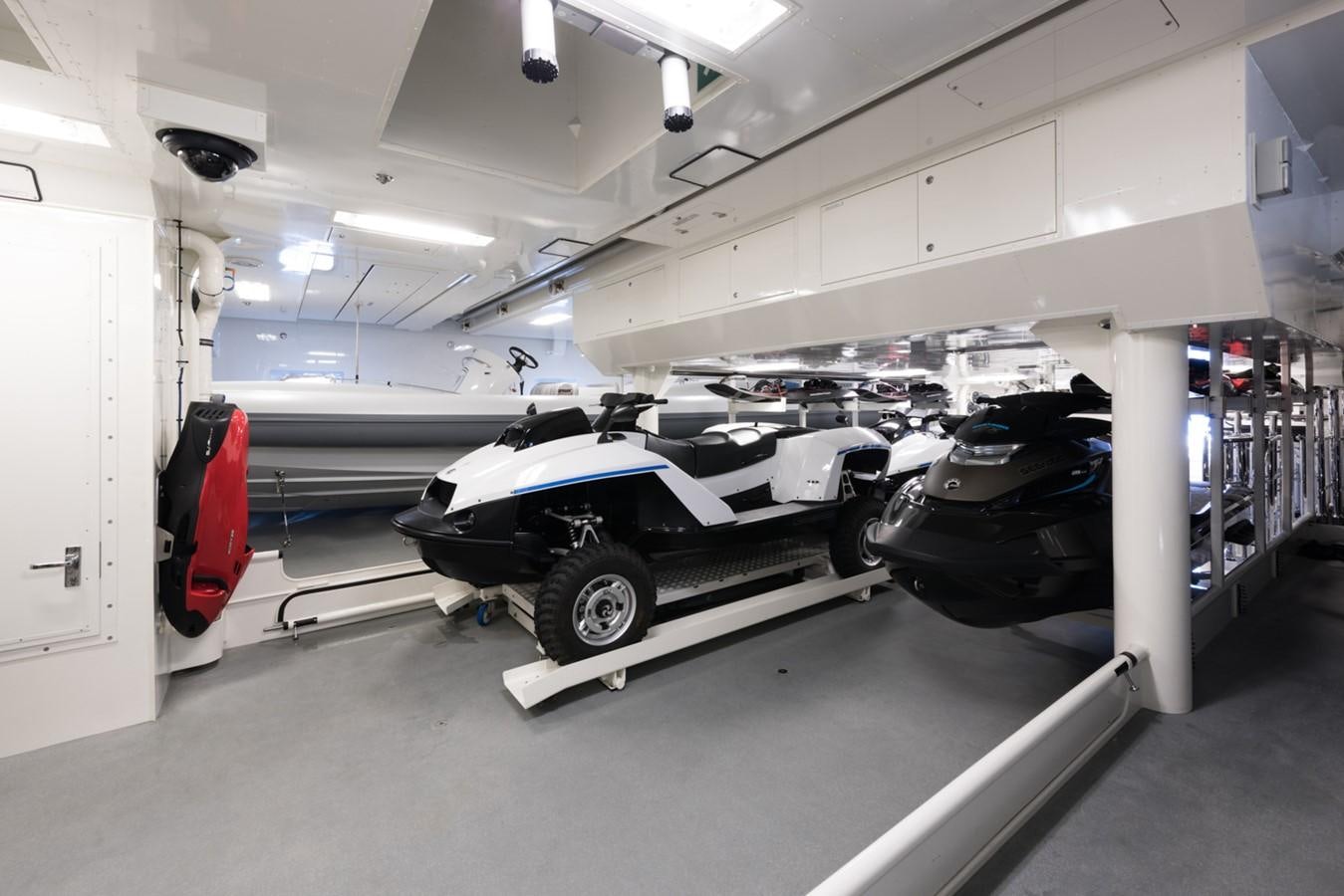 a black and white car parked in a garage aboard PLVS VLTRA Yacht for Sale