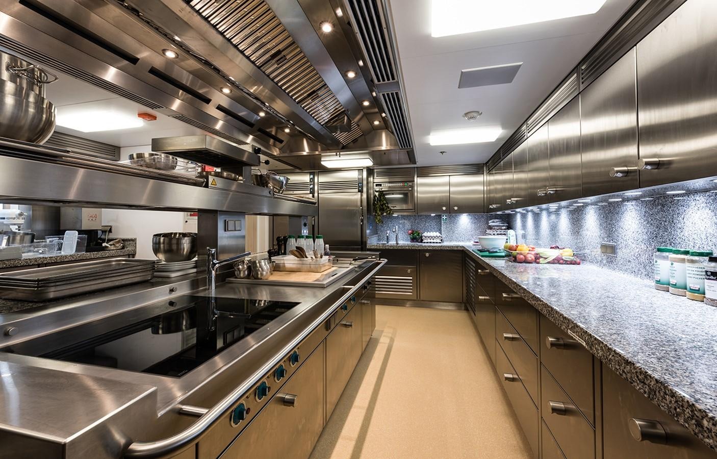 a large kitchen with stainless steel appliances aboard PLVS VLTRA Yacht for Sale