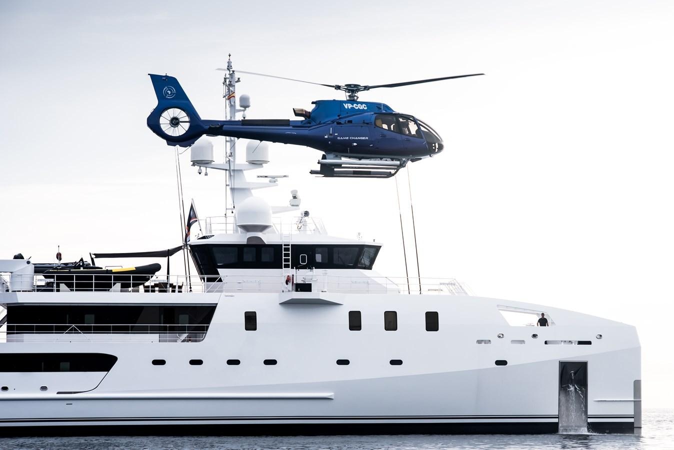a helicopter flying over a ship aboard GAME CHANGER Yacht for Sale