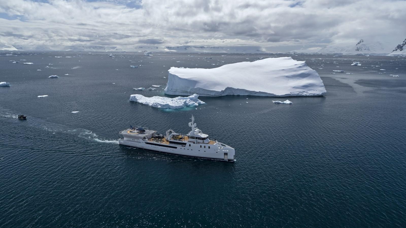 a ship in the water with icebergs in the background aboard GAME CHANGER Yacht for Sale