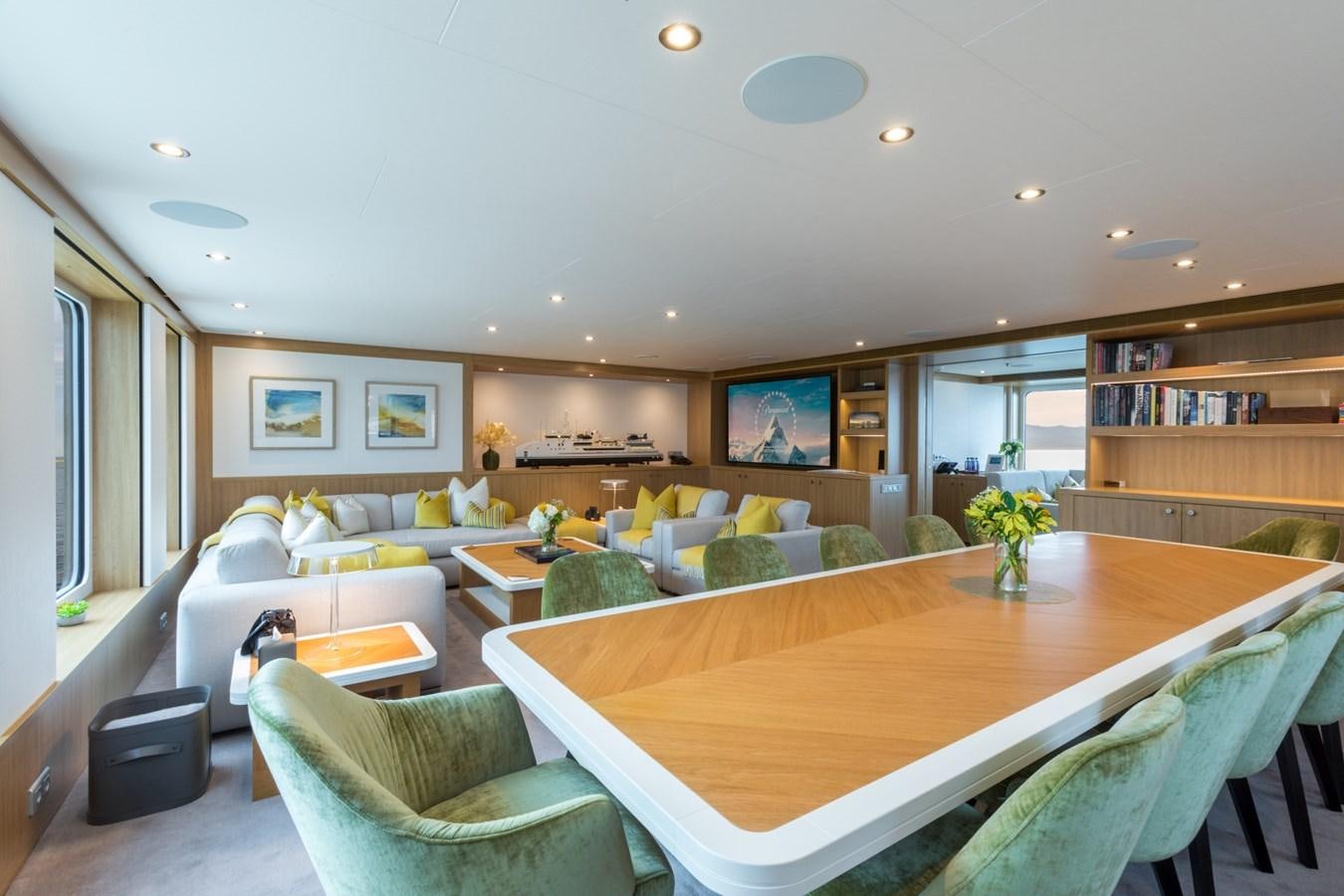 a living room with a table and chairs aboard GAME CHANGER Yacht for Sale
