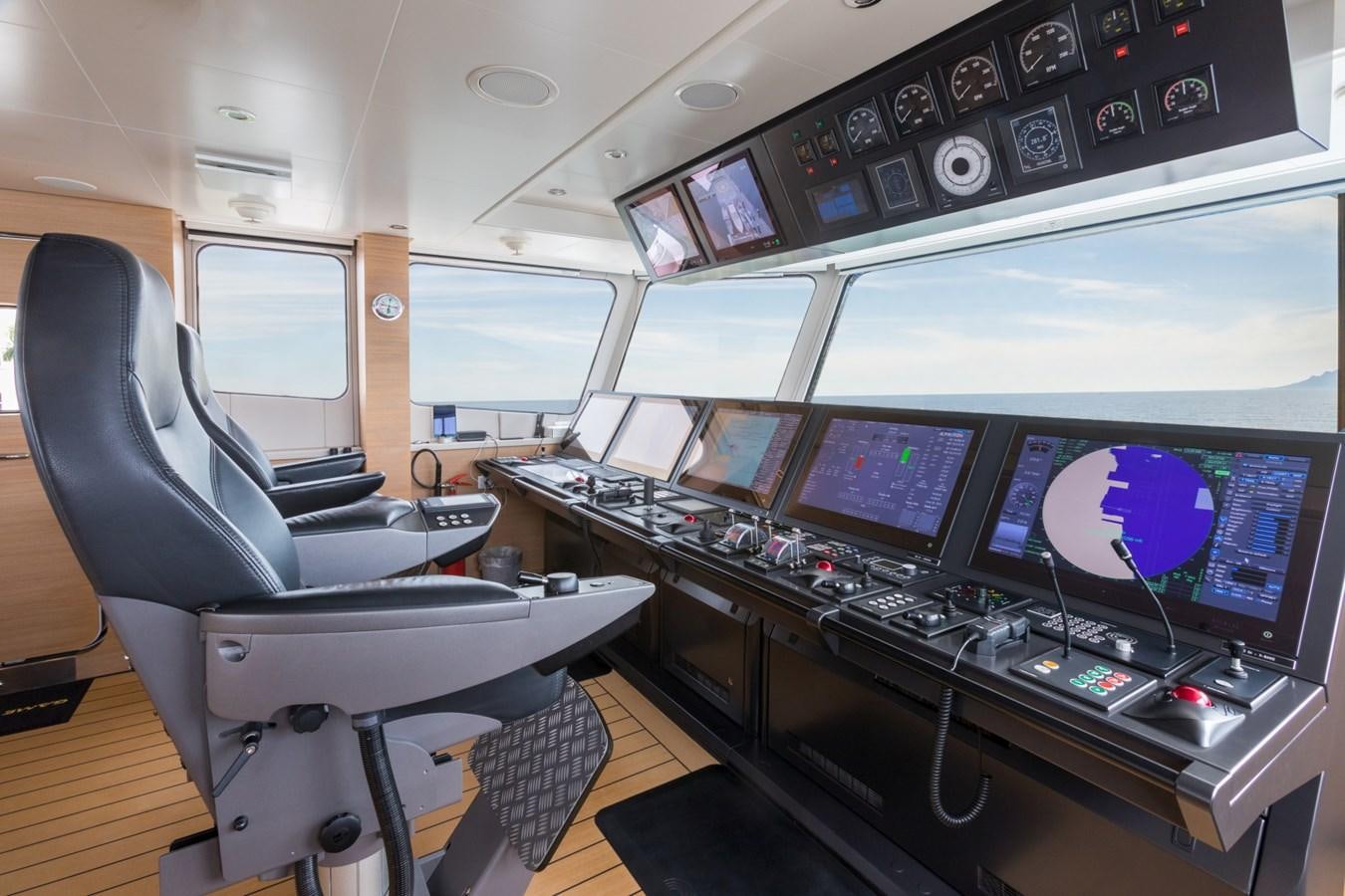 a control room with several monitors aboard GAME CHANGER Yacht for Sale