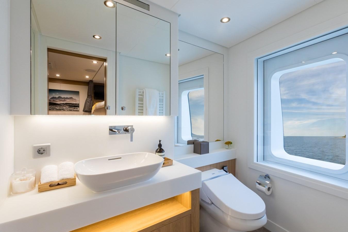 a bathroom with a large mirror aboard GAME CHANGER Yacht for Sale