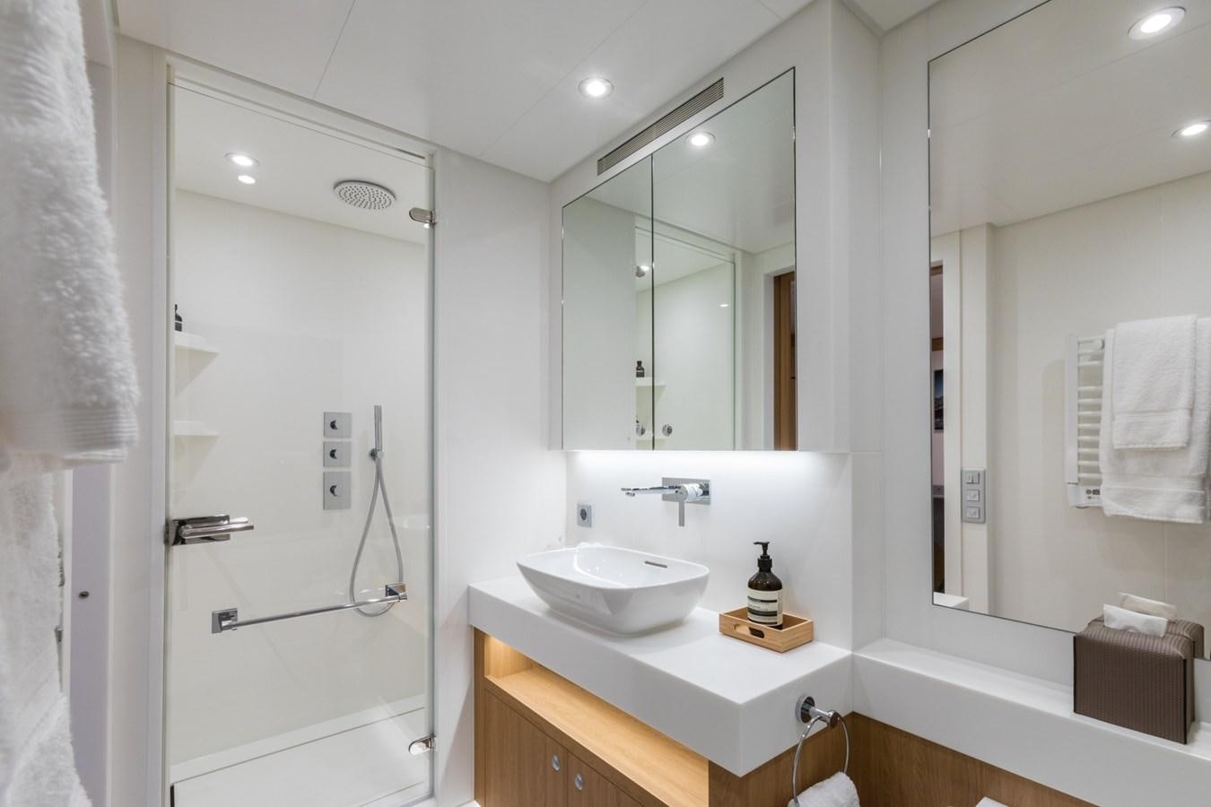 a bathroom with a sink and a mirror aboard GAME CHANGER Yacht for Sale