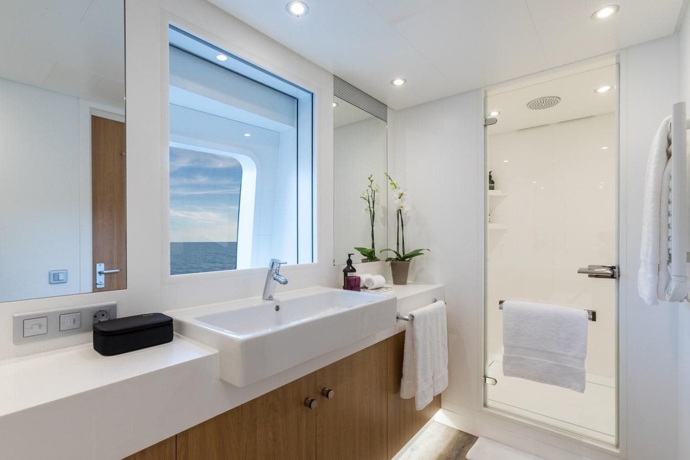 a bathroom with a large window aboard GAME CHANGER Yacht for Sale