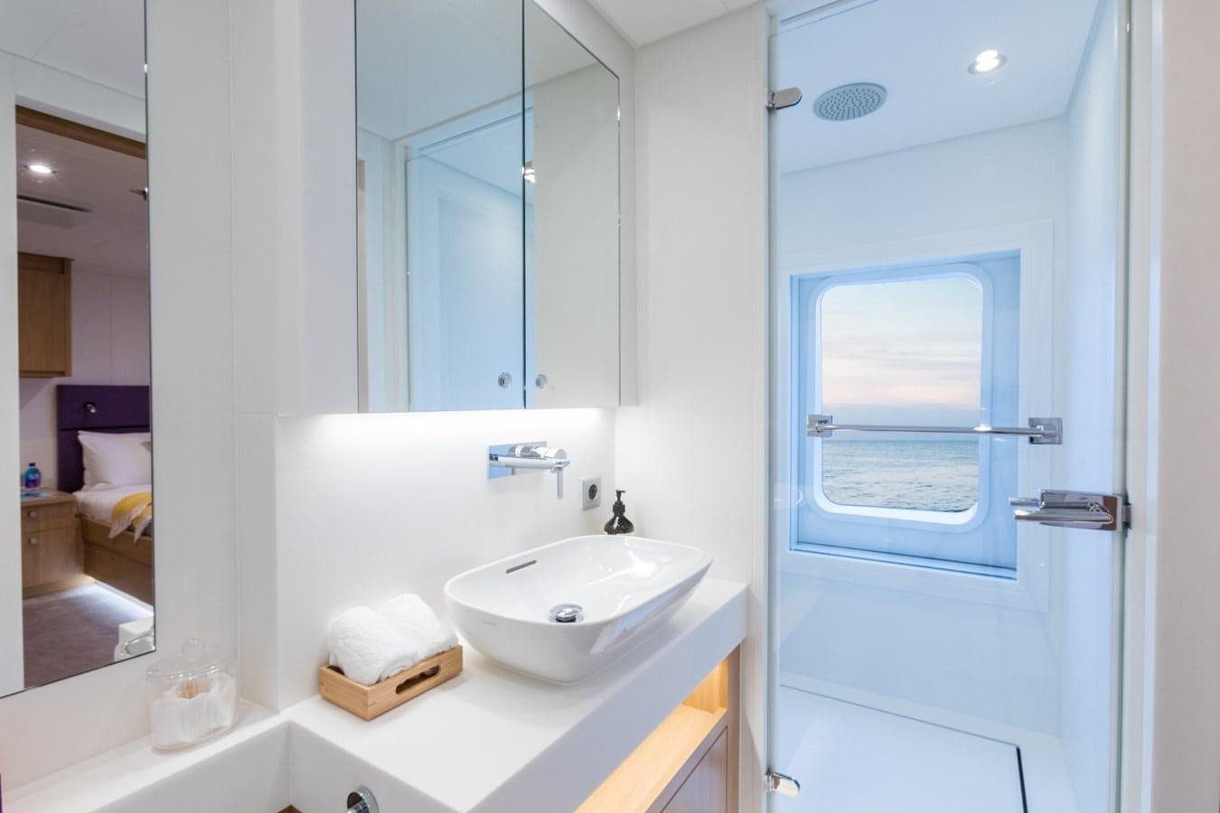 a bathroom with a sink and a mirror aboard GAME CHANGER Yacht for Sale