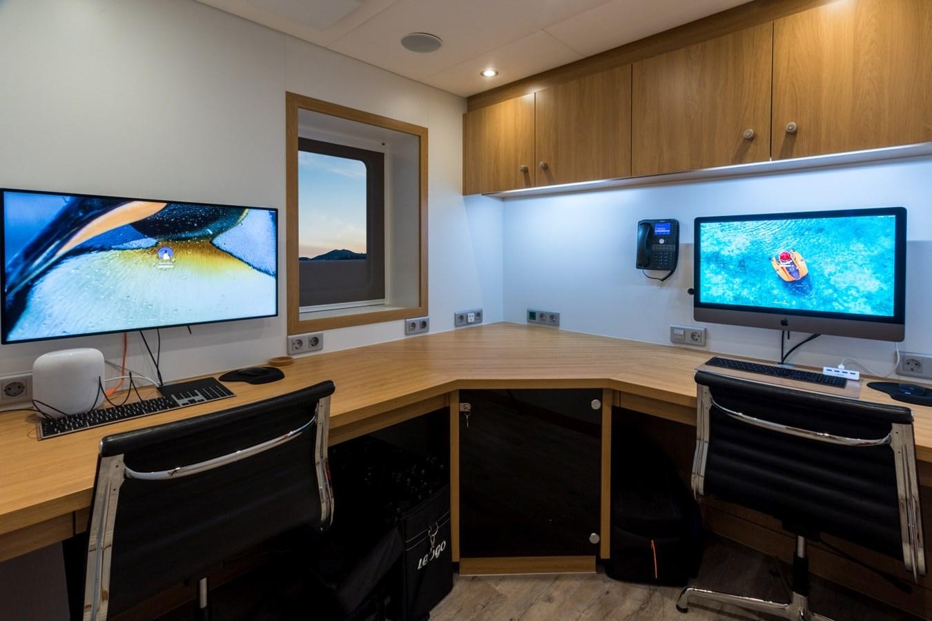 a room with a desk and chairs aboard GAME CHANGER Yacht for Sale