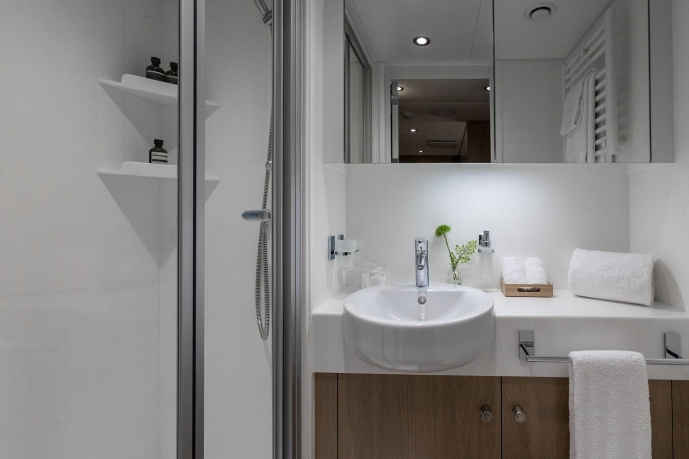 a bathroom with a sink and mirror aboard GAME CHANGER Yacht for Sale