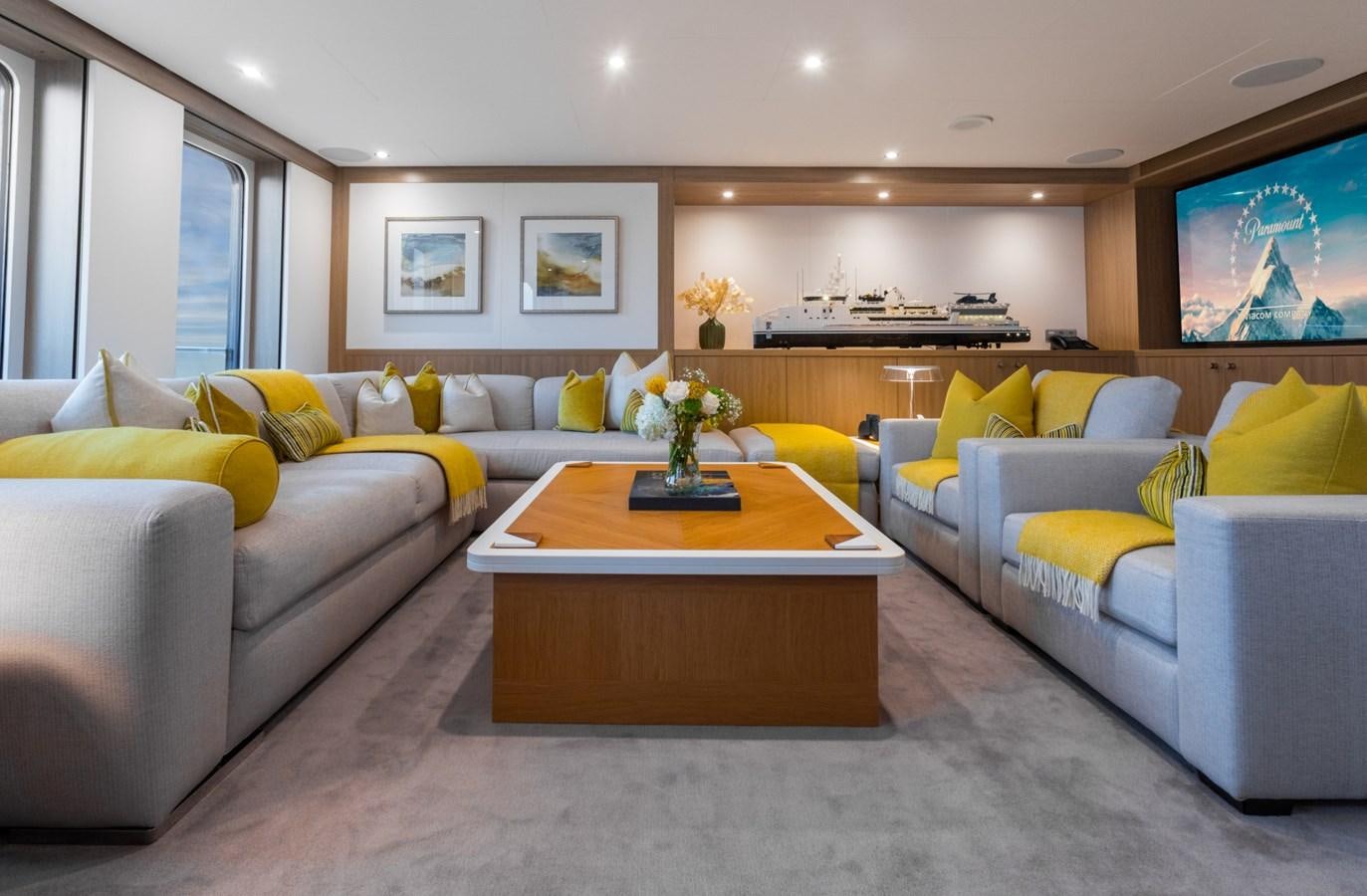 a living room with a couch and a coffee table aboard GAME CHANGER Yacht for Sale
