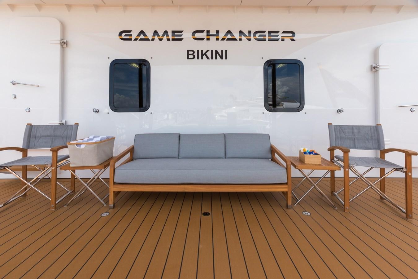 a room with a couch and chairs aboard GAME CHANGER Yacht for Sale
