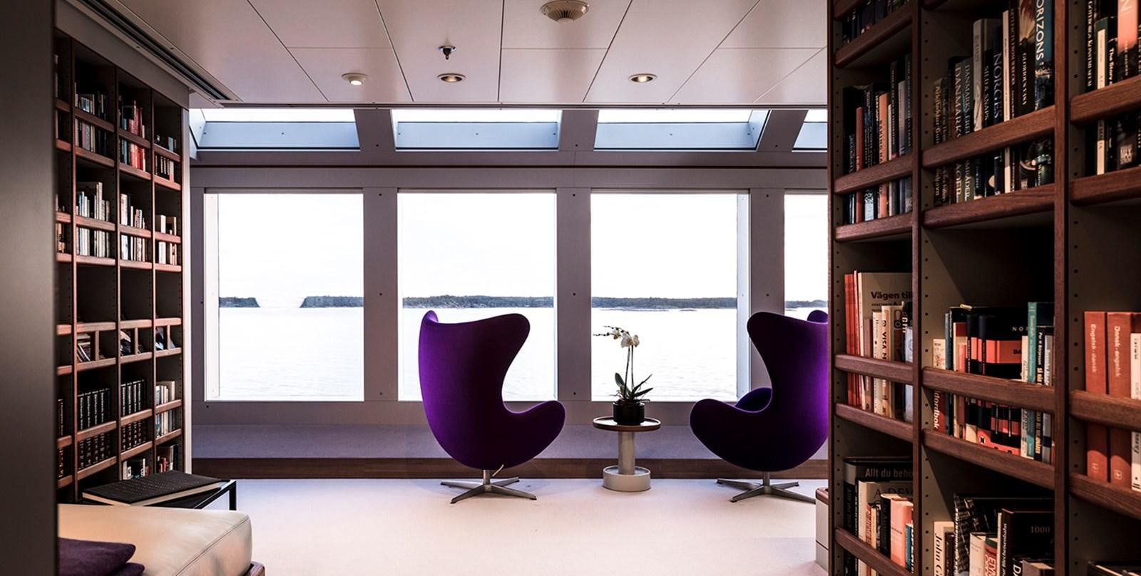 a purple chair in a room aboard SKAT Yacht for Sale