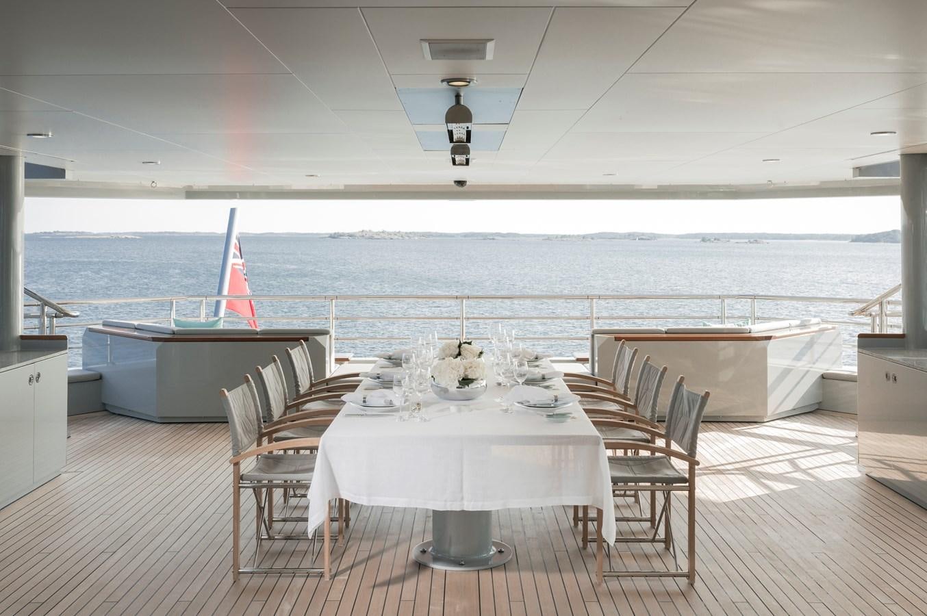 a table and chairs on a deck aboard SKAT Yacht for Sale