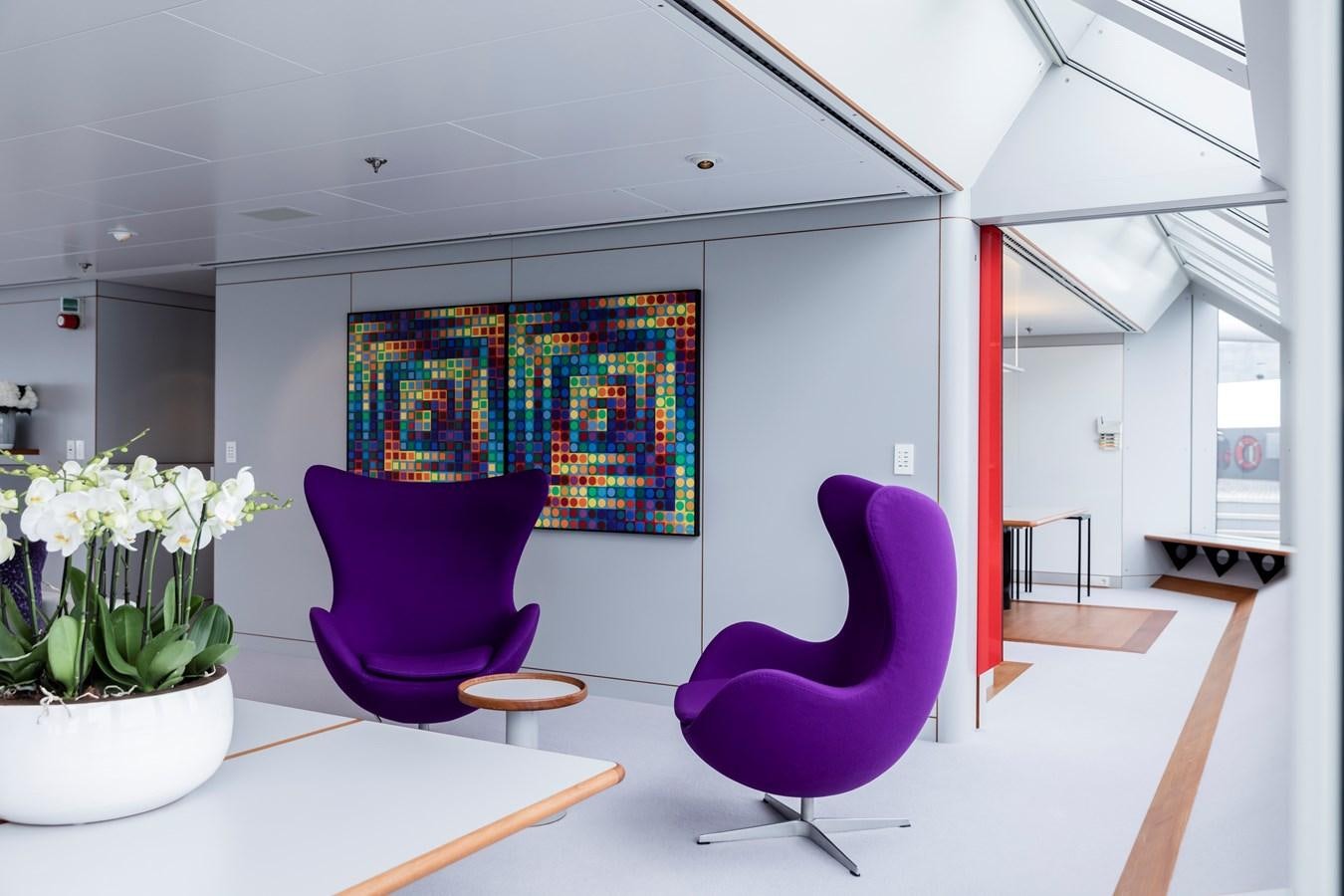 a room with a table chairs and a planter aboard SKAT Yacht for Sale