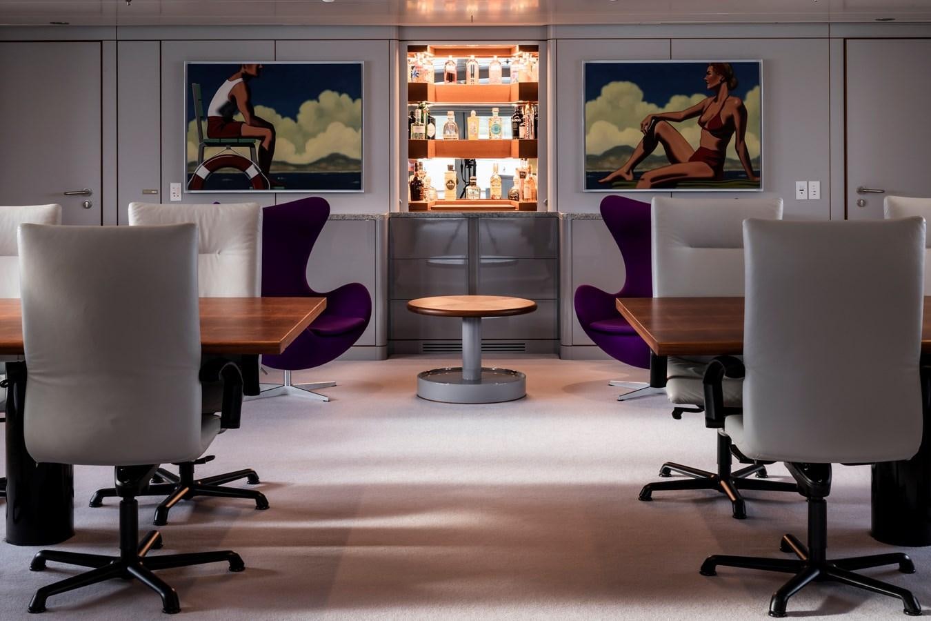 a room with a table and chairs aboard SKAT Yacht for Sale