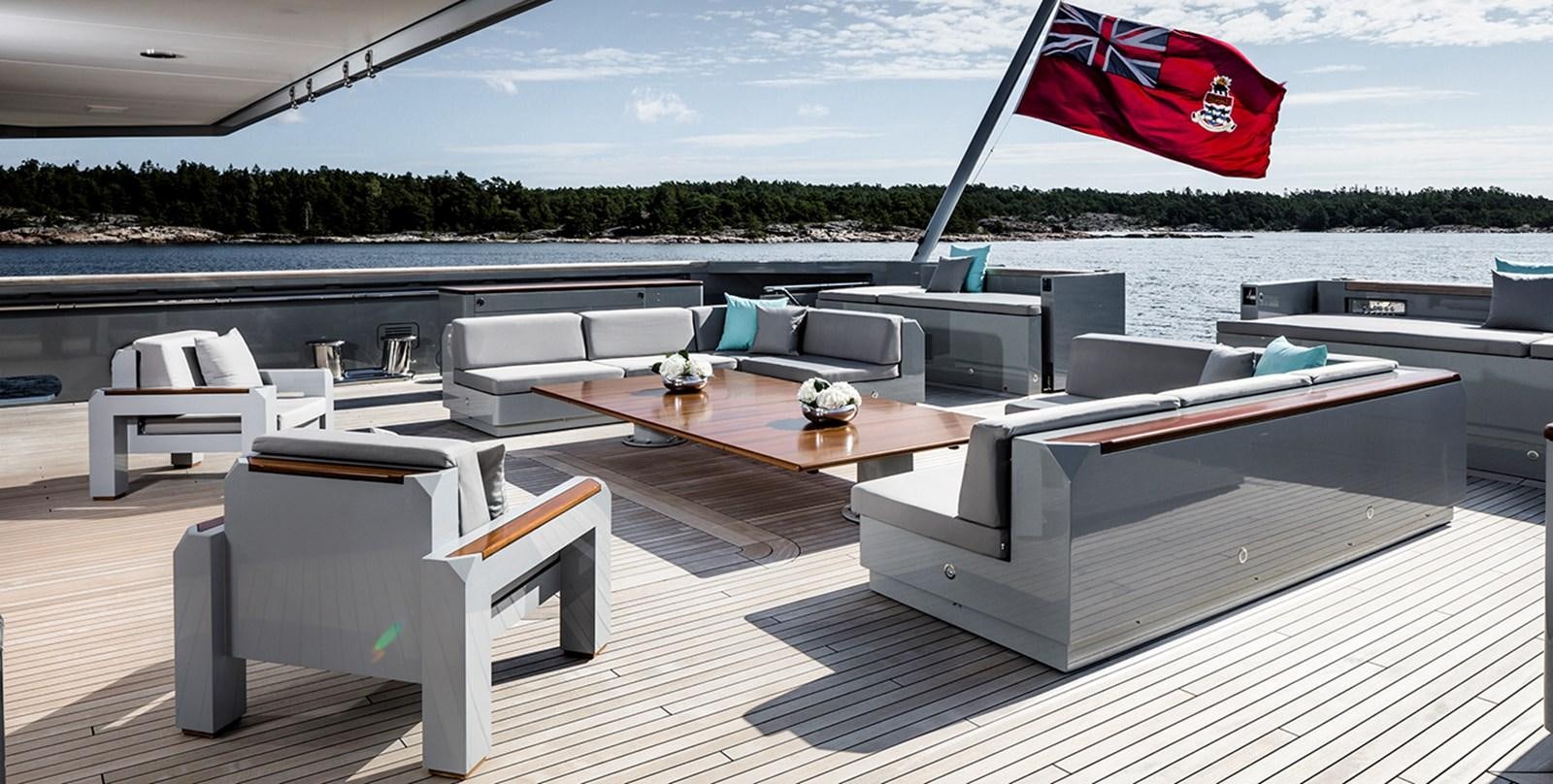 a deck with a table and chairs aboard SKAT Yacht for Sale