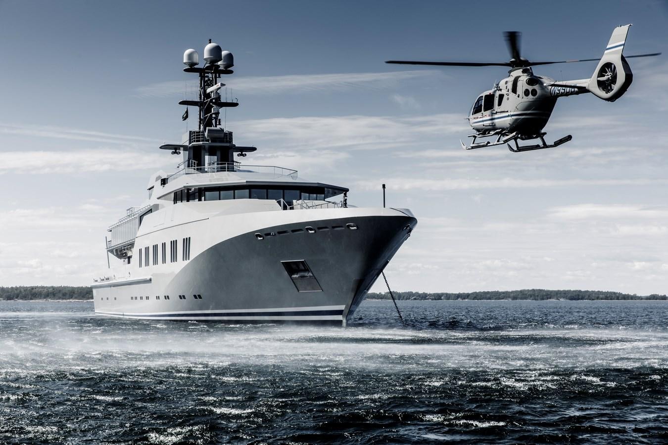 a helicopter flying over a boat aboard SKAT Yacht for Sale