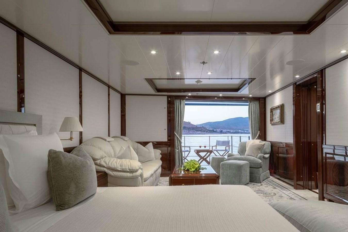 a large bedroom with a balcony aboard LA FAMILIA Yacht for Sale