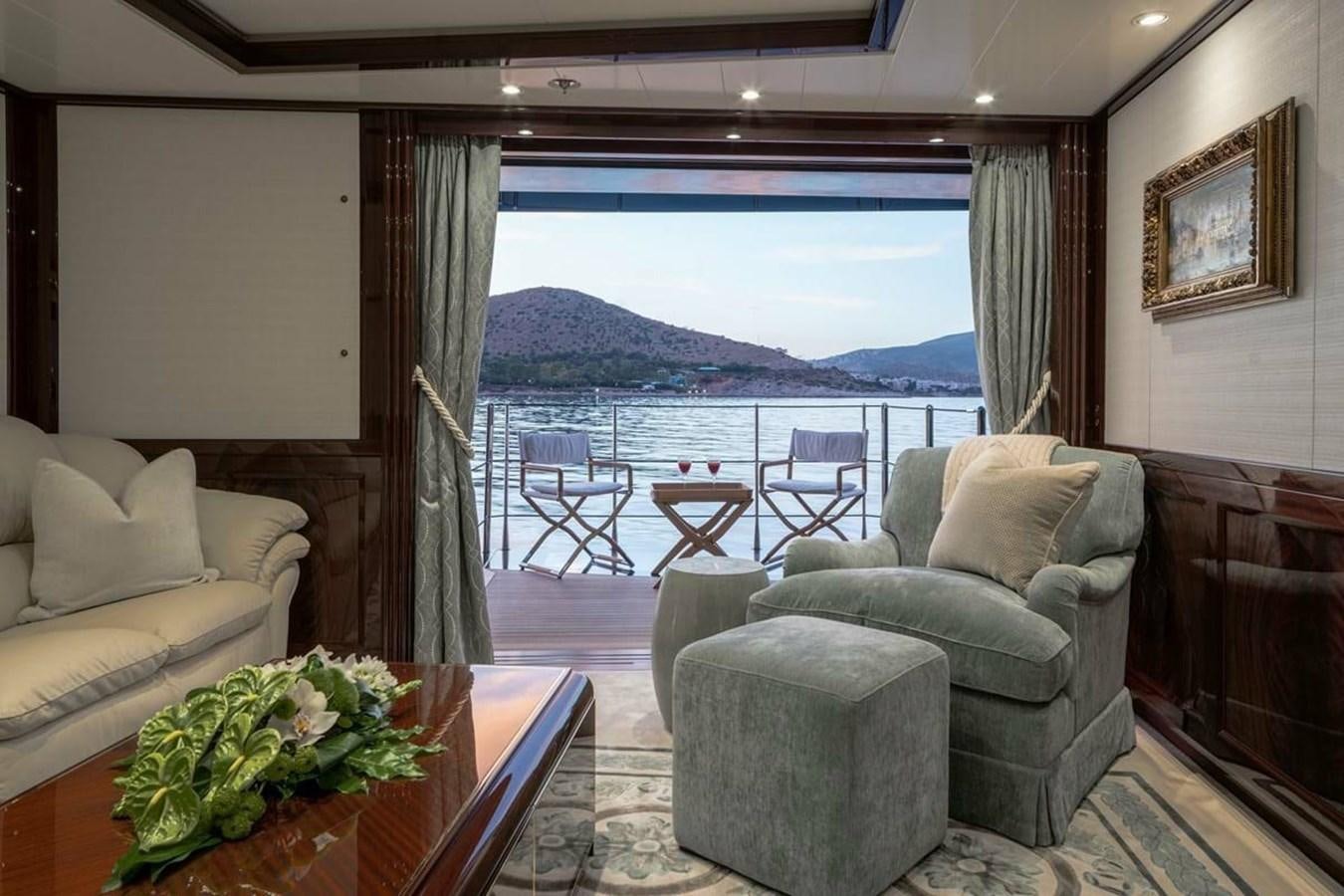 a living room with a large balcony aboard LA FAMILIA Yacht for Sale