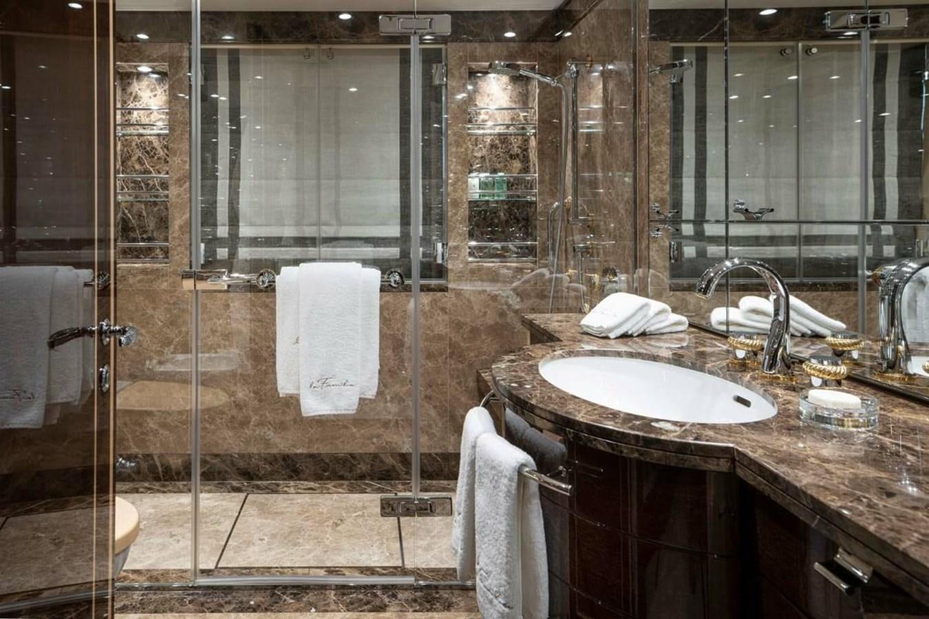 a bathroom with a large glass shower aboard LA FAMILIA Yacht for Sale