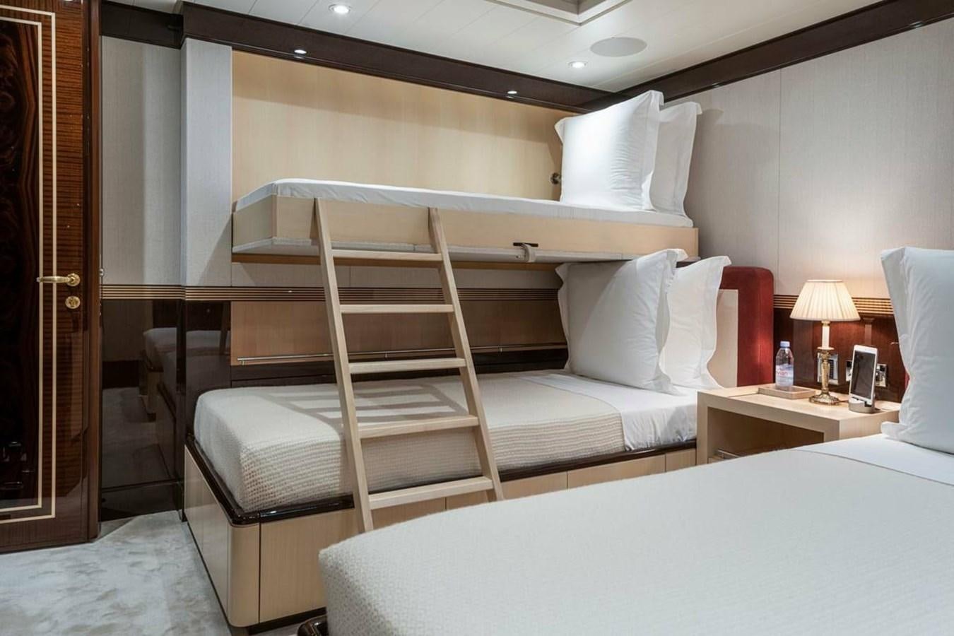 a bed with a white bed frame aboard LA FAMILIA Yacht for Sale