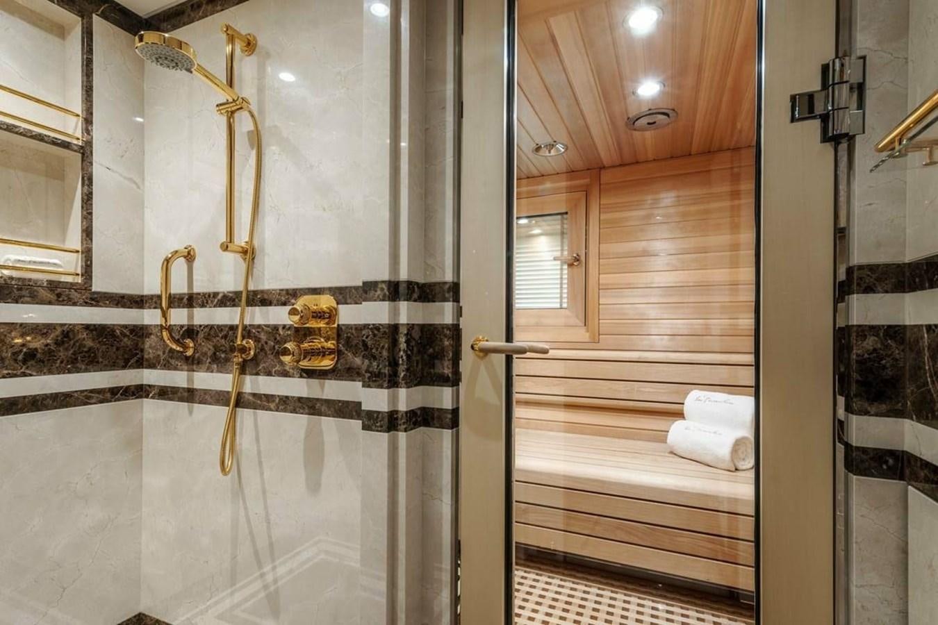 a gold statue in a bathroom aboard LA FAMILIA Yacht for Sale