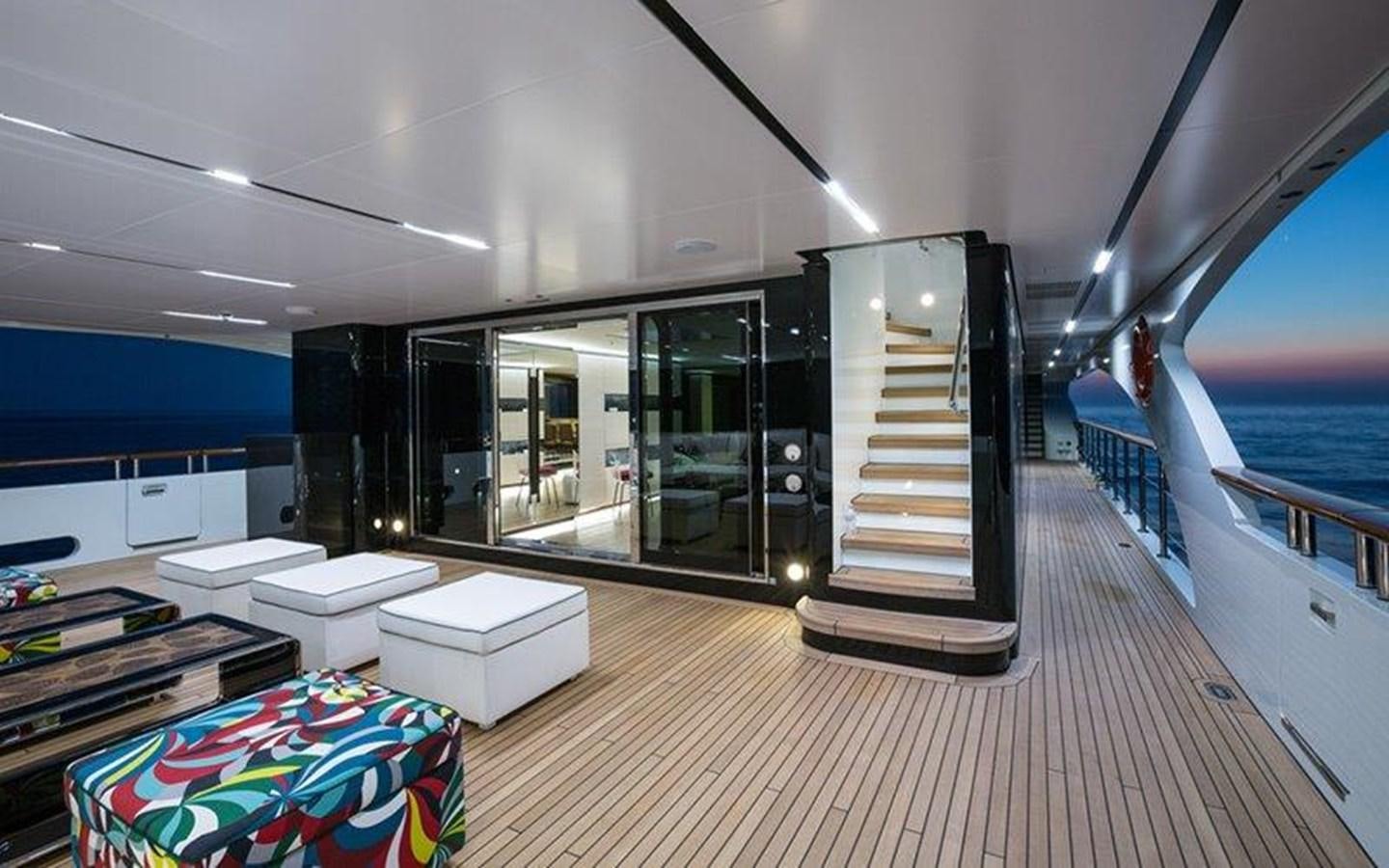 a room with a large glass door and a deck with a pool aboard OCEAN PARADISE Yacht for Sale