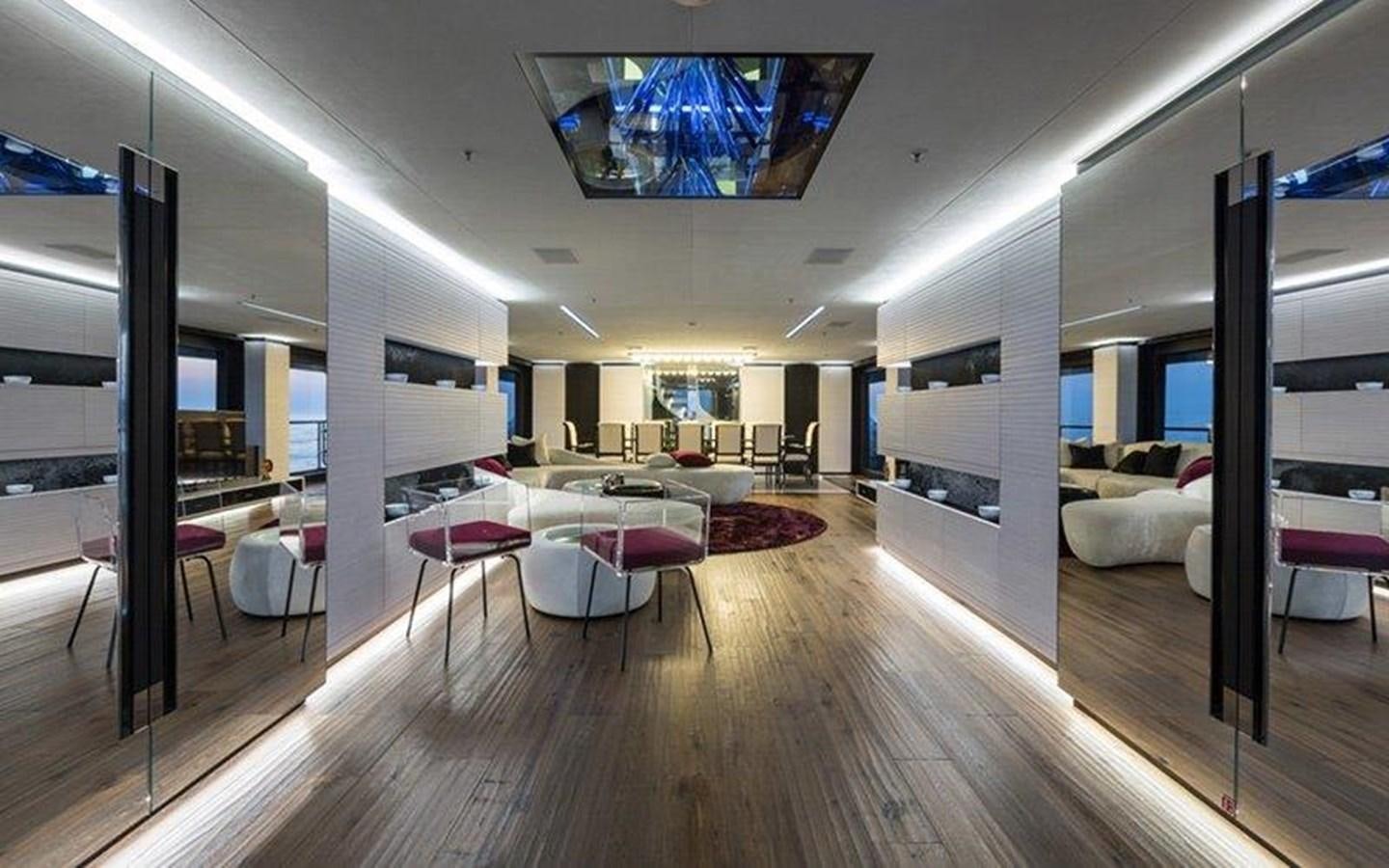 a room with a large wood floor aboard OCEAN PARADISE Yacht for Sale