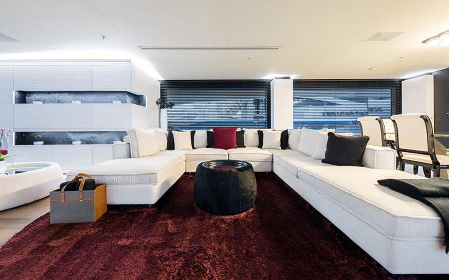 a living room with a couch and a table aboard OCEAN PARADISE Yacht for Sale