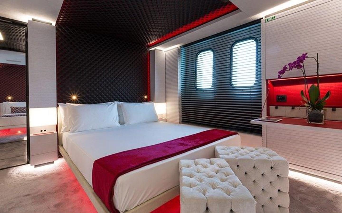 a room with a bed and a window aboard OCEAN PARADISE Yacht for Sale