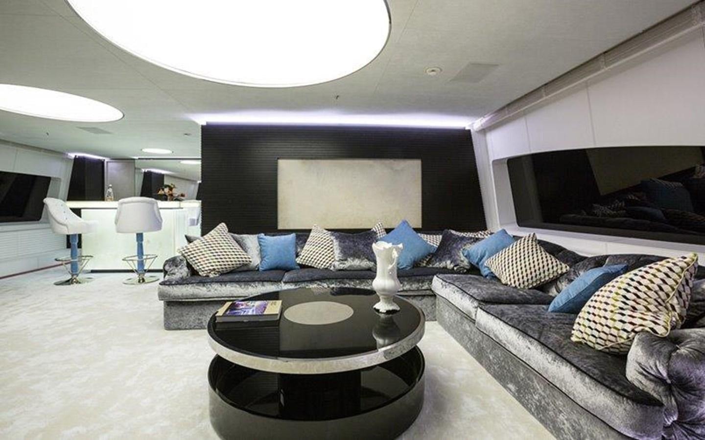 a living room with a couch and a coffee table aboard OCEAN PARADISE Yacht for Sale