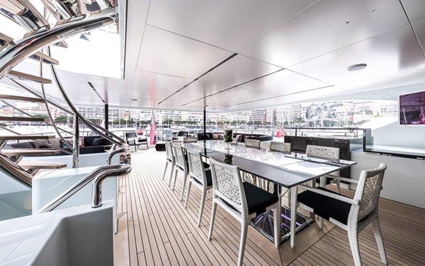 a room with tables and chairs aboard OCEAN PARADISE Yacht for Sale