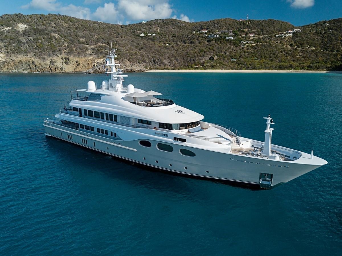 a white yacht on the water aboard FORTUNATE SUN Yacht for Sale