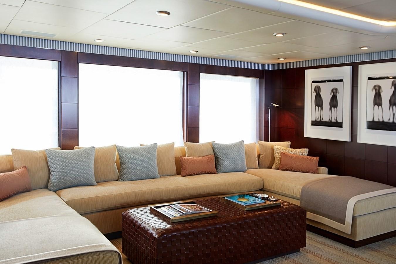 a living room with a couch and a coffee table aboard FORTUNATE SUN Yacht for Sale