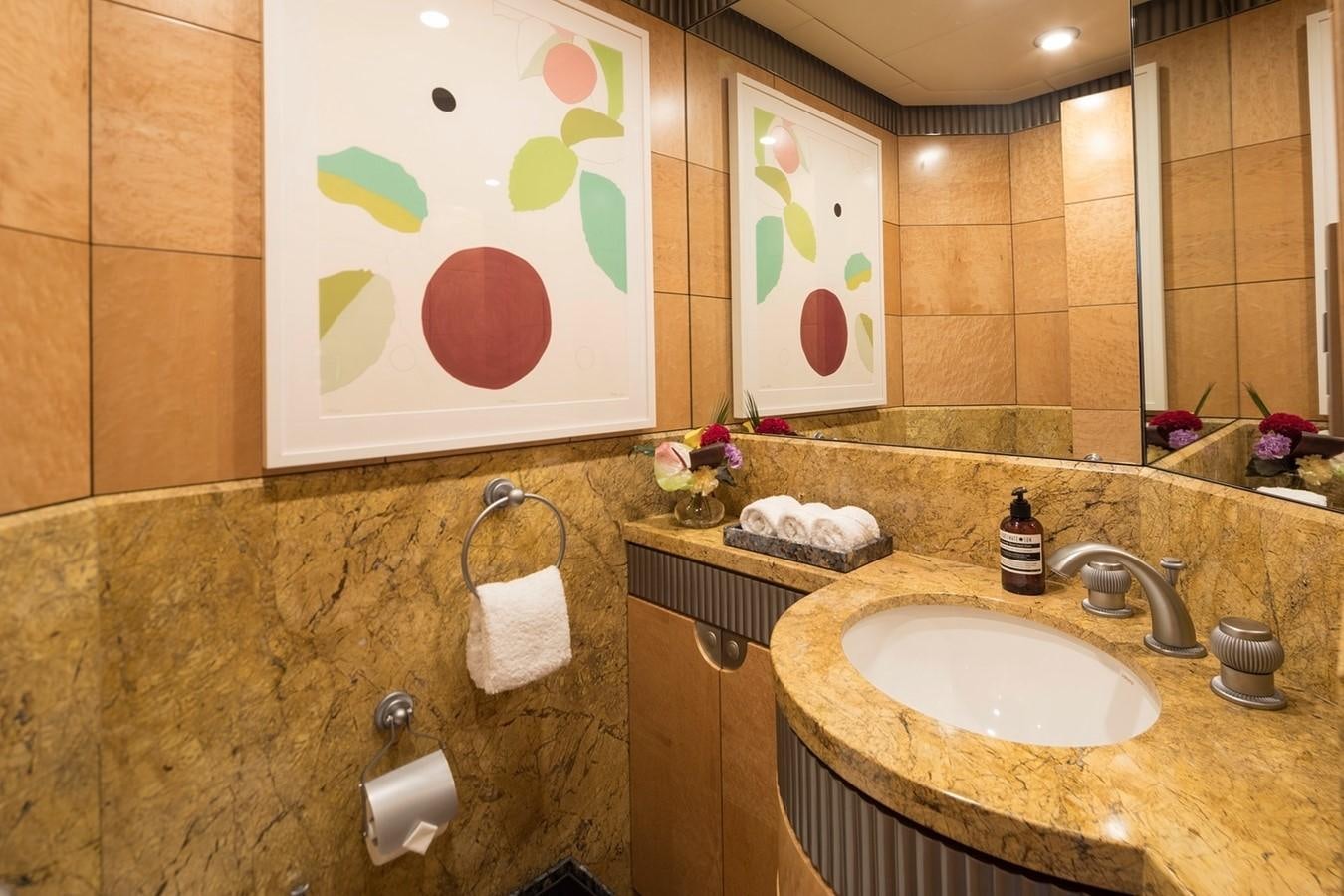 a bathroom with a sink and a mirror aboard FORTUNATE SUN Yacht for Sale