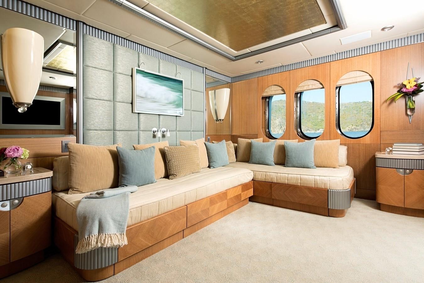 a large living room with a large bed and a large mirror aboard FORTUNATE SUN Yacht for Sale