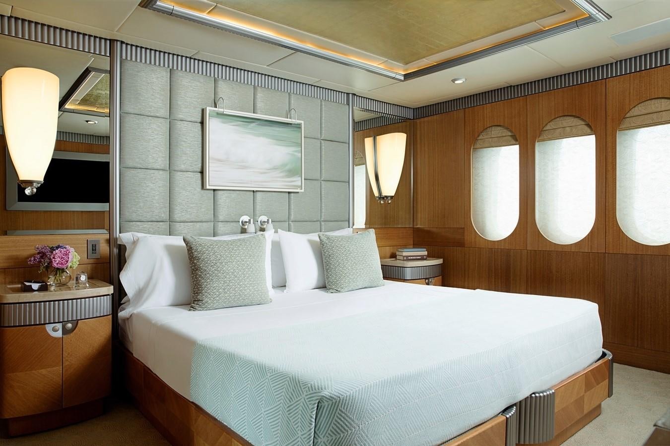 a bed with white sheets aboard FORTUNATE SUN Yacht for Sale