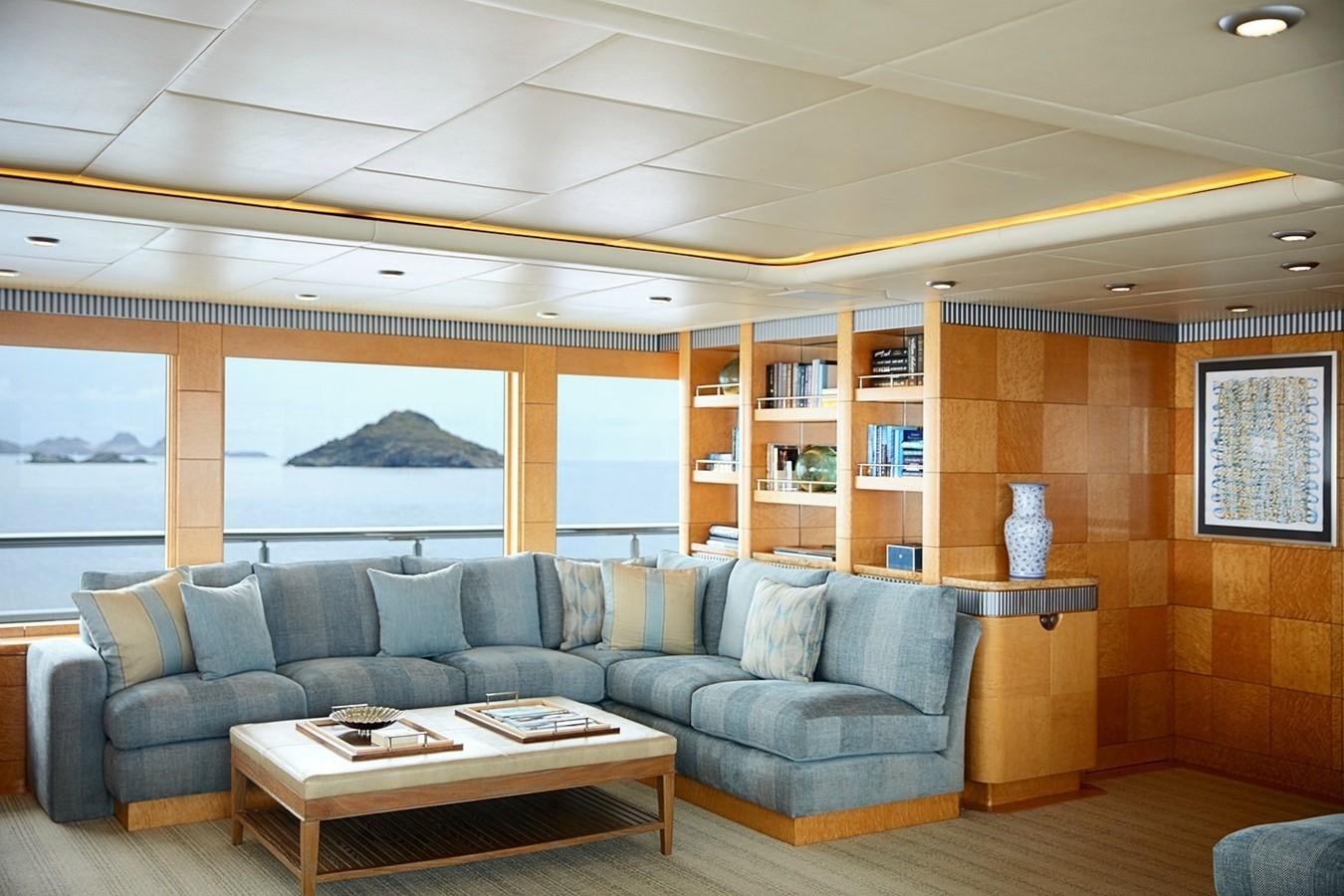 a living room with a large window aboard FORTUNATE SUN Yacht for Sale