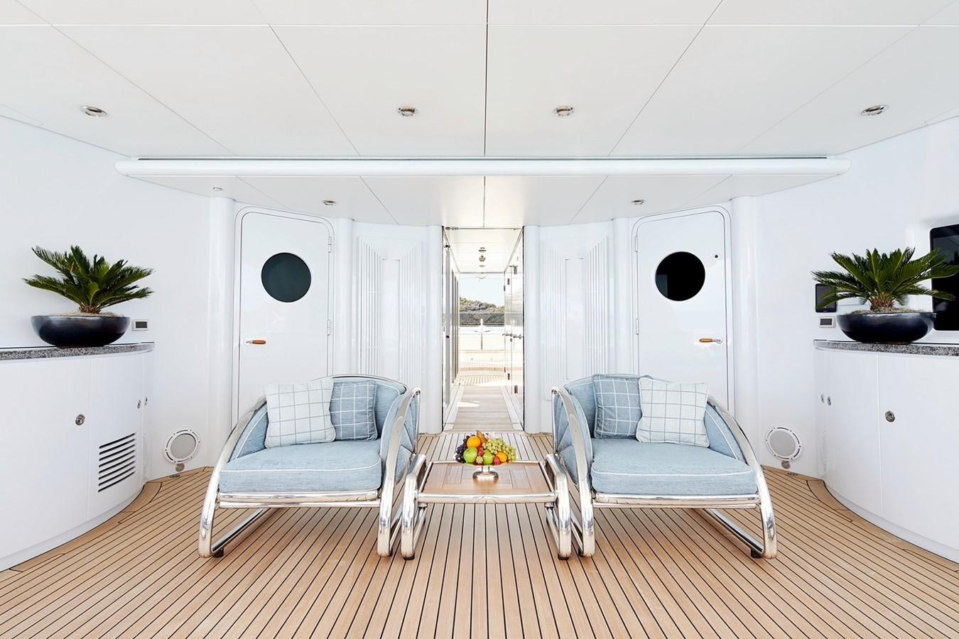 a living room with a couch and a table aboard FORTUNATE SUN Yacht for Sale