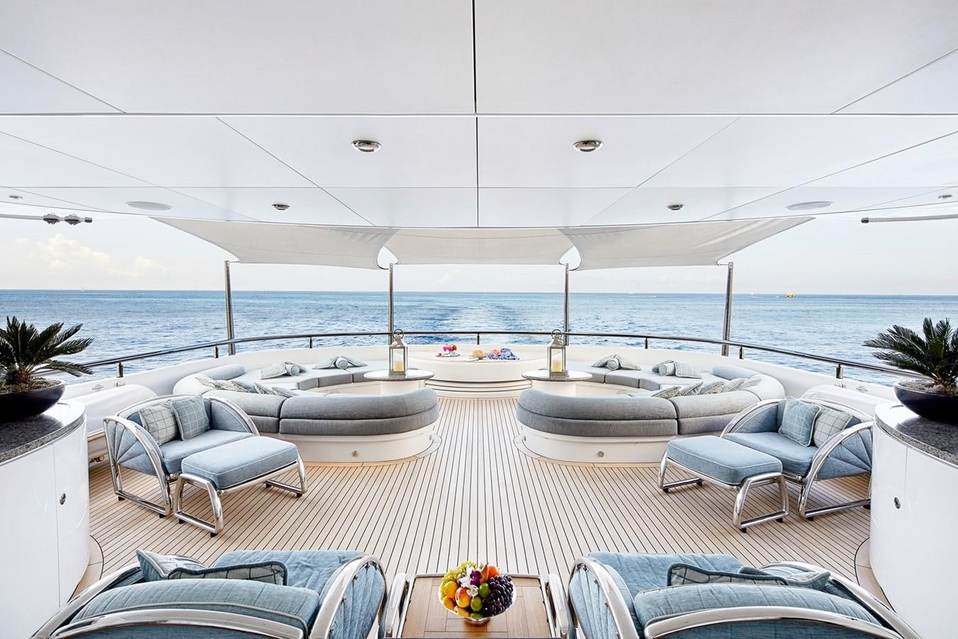 a room with a large body of water and furniture aboard FORTUNATE SUN Yacht for Sale