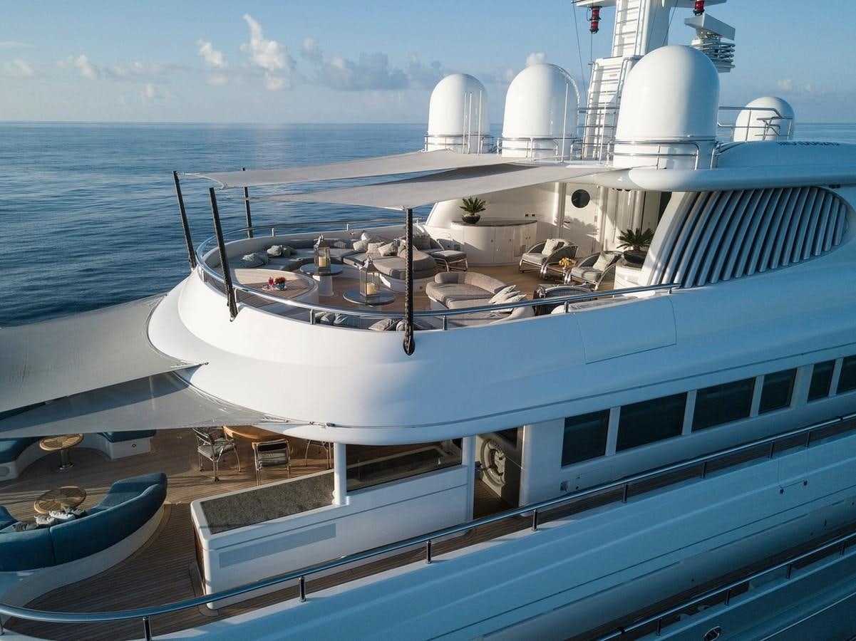 a large white boat on a body of water aboard FORTUNATE SUN Yacht for Sale