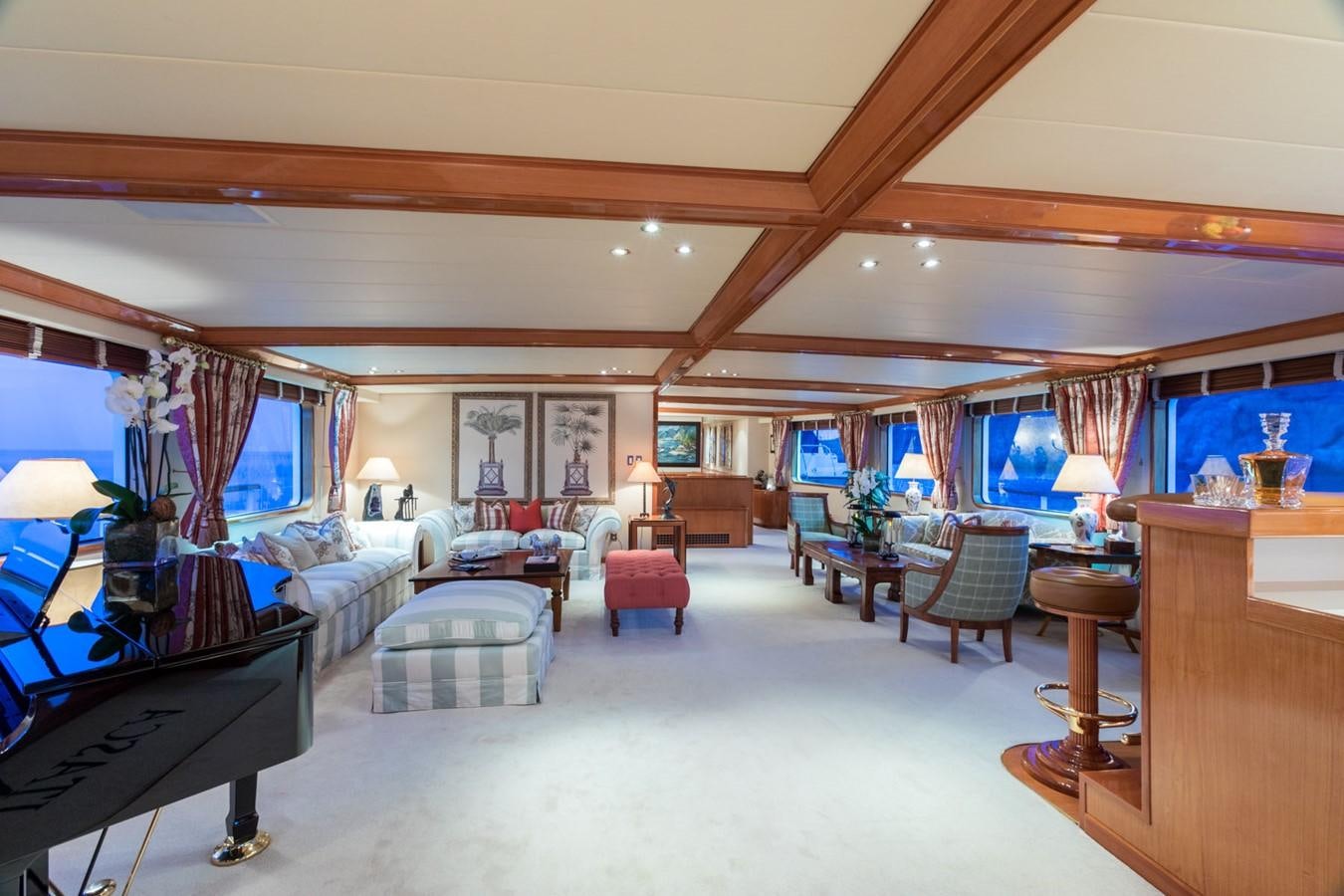 a large living room with a large window aboard ITASCA Yacht for Sale