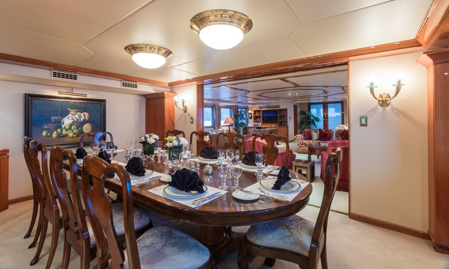 a dining room with a table and chairs aboard ITASCA Yacht for Sale