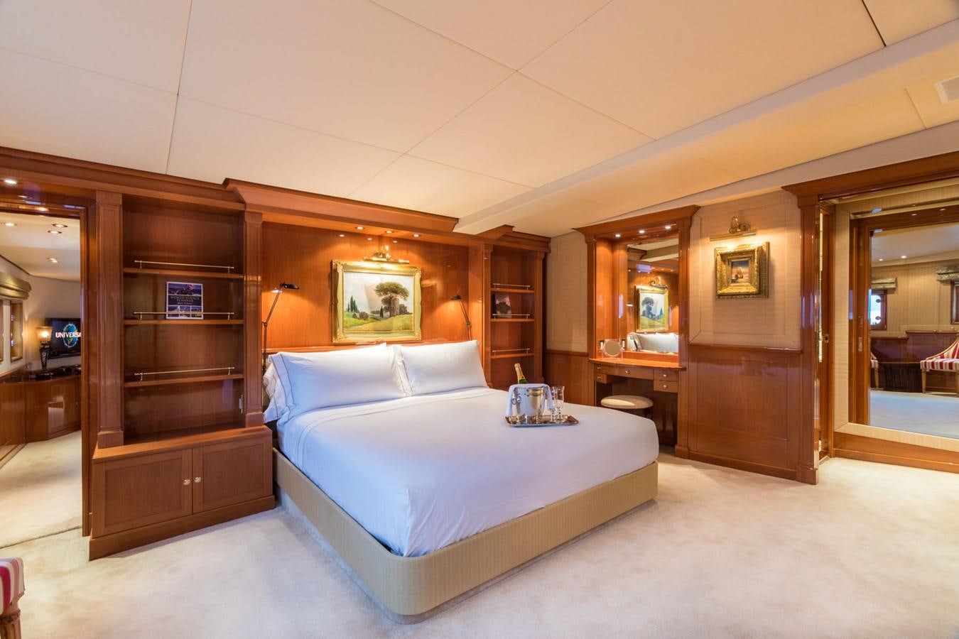 a bedroom with a bed and a desk aboard ITASCA Yacht for Sale