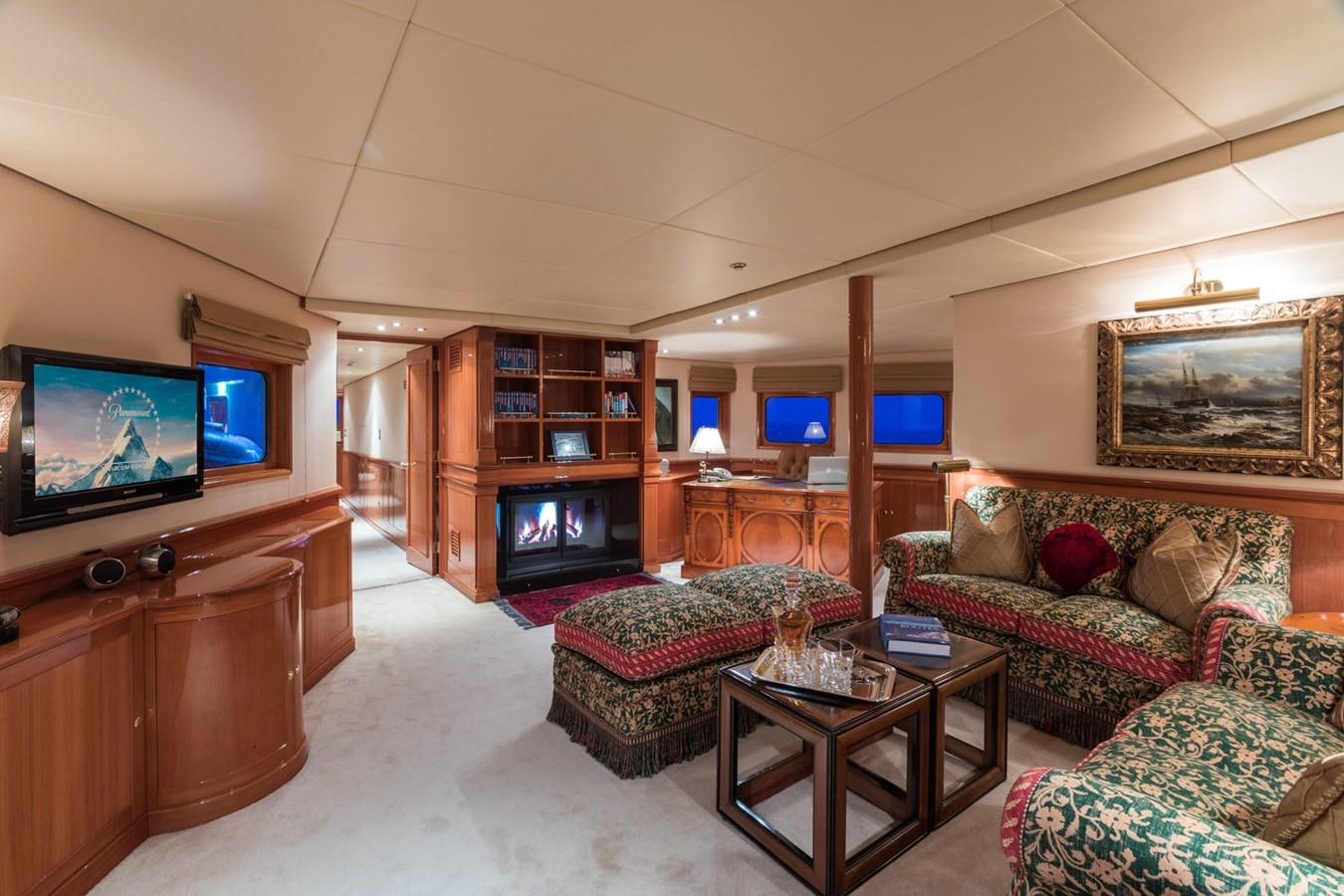 a living room with a fireplace aboard ITASCA Yacht for Sale