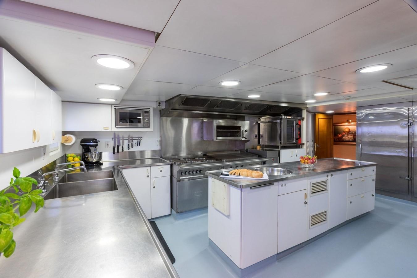 a kitchen with white cabinets aboard ITASCA Yacht for Sale